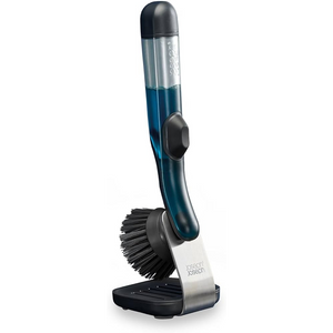 Joseph Joseph SinkTech soap dispenser dish brush with stand featuring a blue liquid reservoir, black bristles, white and silver base, and black cap on white background