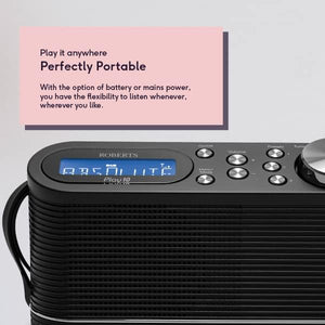 Roberts PLAY10BK portable DAB FM digital radio in black with blue LCD display, control buttons and ribbed texture, shown with pink product information card describing portable battery and mains power options