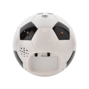 White and black soccer ball shaped alarm clock with touch lens features, displaying large brown eyes and speaker grille, front view on white background