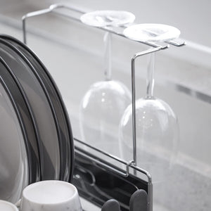 Blackmoor Deluxe Dish Drainer in black with chrome accents featuring clear glass wine glass holders and white plate storage compartment on modern kitchen counter