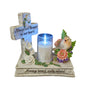 Stone grave memorial featuring a blue cross with white roses, LED candle, decorative bird figurine with pink and purple flowers, engraved with "Always loved, sadly missed" and "Always and Forever in our hearts"
