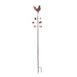 Rustic copper rooster weather vane with directional cardinal points (N, S, E, W) mounted on tall metal pole with ground stake
