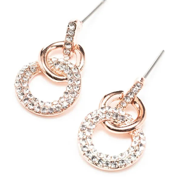 Rose gold interlocking circular earrings with crystal rhinestone embellishments and silver ear wires on white background