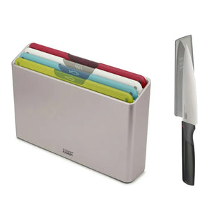 Joseph Joseph Folio 4 Piece Icon Chopping Board Set in white container with color-coded boards in red, cream, lime green and turquoise, displayed with matching stainless steel chef knife with black handle