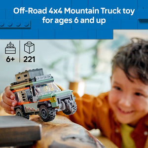 LEGO Off-Road 4x4 Mountain Truck set 60447 with 221 pieces for ages 6 and up, featuring a colorful tan, green and orange buildable truck with large black wheels, displayed in child's hands against sandy surface with blurred outdoor background