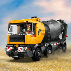 LEGO cement mixer truck 60478 with yellow cab, black rotating drum, red and white safety markings, detailed windows and cab interior, six wheels, shown on dusty ground against blue sky