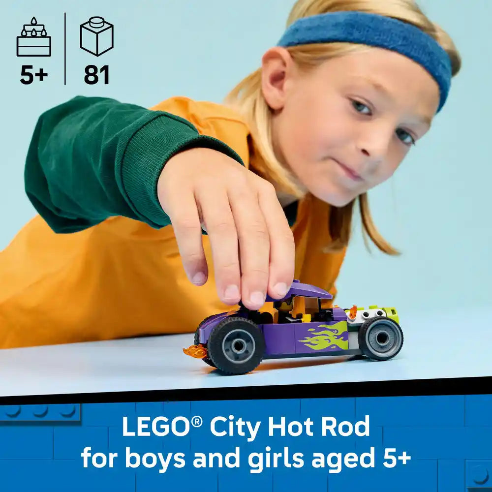 Young child with blonde hair and blue headband playing with purple LEGO City Hot Rod car featuring yellow flame details, set 60485 with 81 pieces, recommended for ages 5 and up