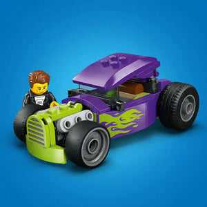 LEGO Hot Rod 60485 set featuring a bright lime green and purple customized hot rod with flame decals, large black wheels, and an opening hood, accompanied by a brown-haired minifigure in black jacket, displayed against a blue background