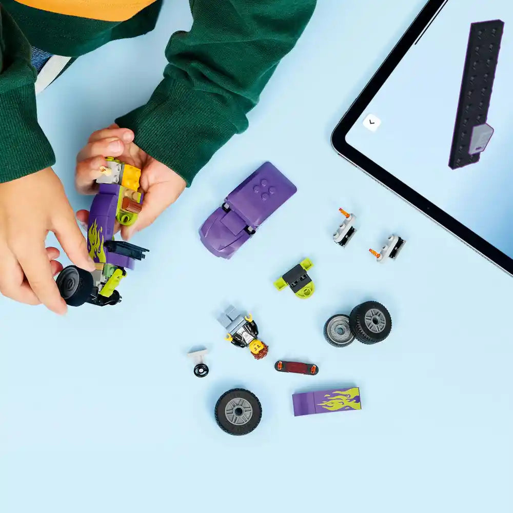 Child in green sweater assembling LEGO Hot Rod 60485 set with yellow and purple brick pieces, wheels, and components displayed on light blue background with instruction manual and remote control visible