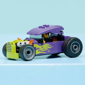 LEGO Hot Rod 60485 purple and lime green buildable car toy with flame decals, oversized black wheels, white goggle eyes, and removable purple canopy roof against light blue background