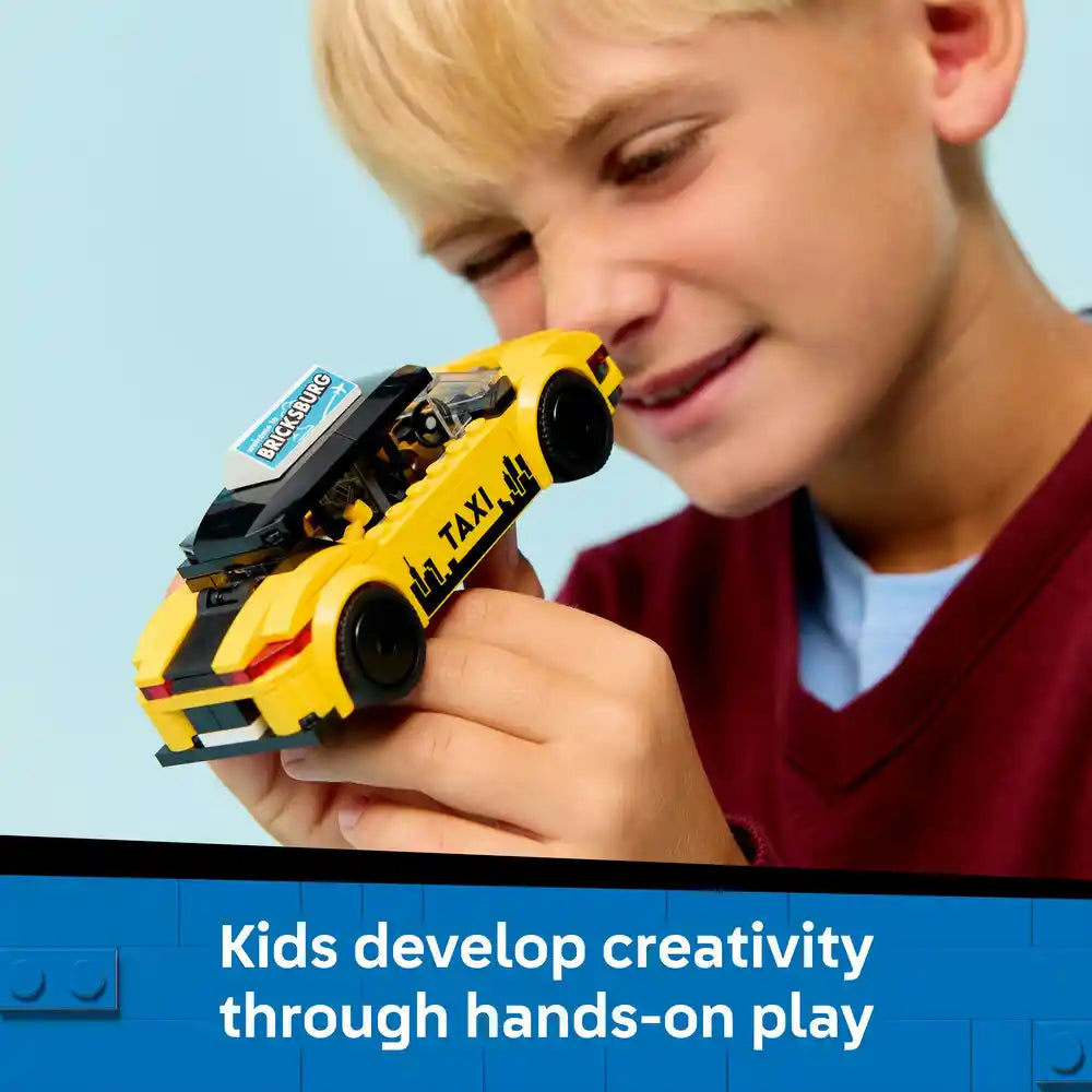 Young child with blonde hair holding a bright yellow LEGO taxi toy car with black accents against a light blue background, with text below stating "Kids develop creativity through hands-on play"