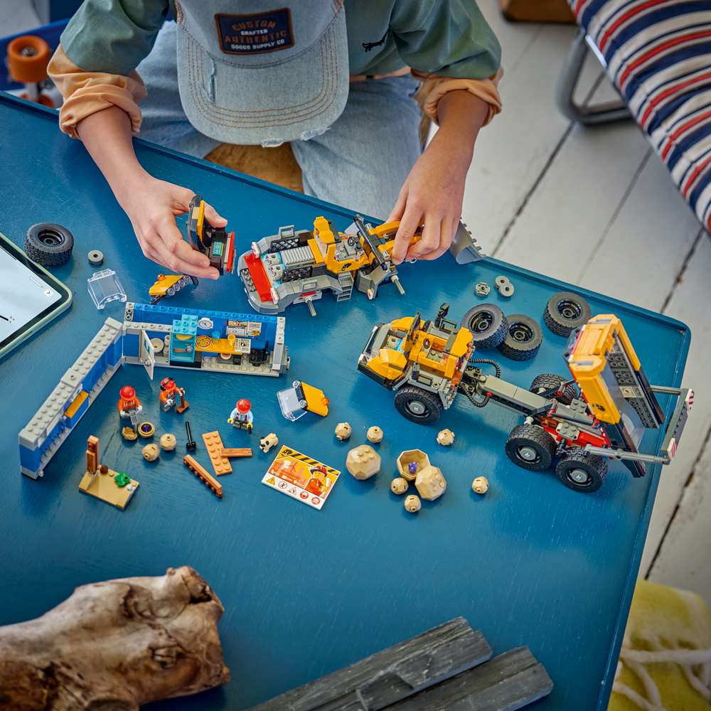 LEGO City Dump Truck & Front End Loader 60494 - a child building the set. 1132 pieces. Ages 8+.