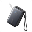 Anker Nano Power Bank 10000mAh 45W in black with digital display showing 100% battery, built-in USB-C cable, and wrist strap attached