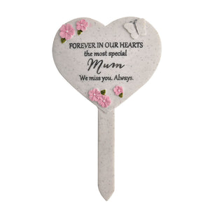 Heart-shaped memorial plaque with floral designs and text on a white background
