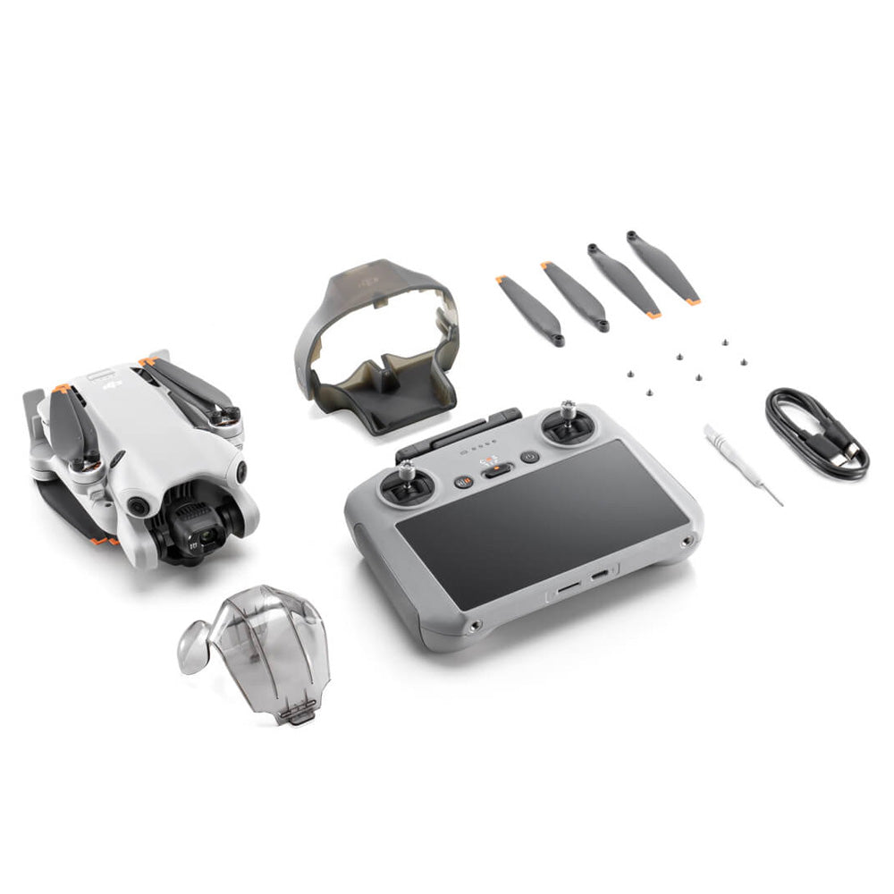 DJI Mini 4 Pro RC 2 drone complete kit displayed with white and gray drone, gray remote controller, VR goggles, four gray propellers with orange accents, protective case, cables and small accessories on white background