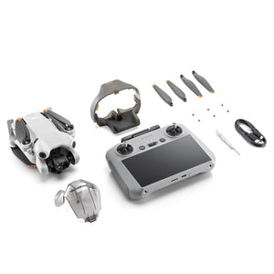 DJI Mini 4 Pro RC 2 drone complete kit displayed with white and gray drone, gray remote controller, VR goggles, four gray propellers with orange accents, protective case, cables and small accessories on white background