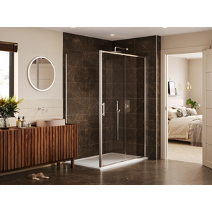 Modern luxury bathroom featuring a Merlyn 6 Series chrome sliding shower enclosure with dark marble-effect tiles, adjacent to a wooden vanity unit with circular illuminated mirror, cream and beige walls, and view into bedroom beyond