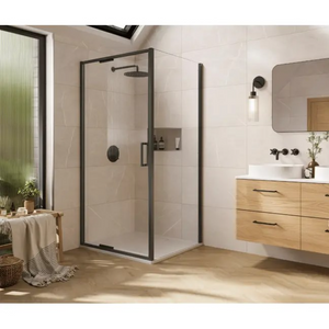 Modern bathroom featuring a matte black framed glass shower enclosure with hinged door, rainfall showerhead, and built-in niche, alongside a wall-mounted light oak vanity unit with white vessel sink, black fixtures, and rounded mirror, with natural light streaming through a tall reeded glass window
