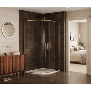 Modern quadrant shower enclosure with curved glass doors and brushed brass frame, featuring a white shower tray, large rainfall showerhead, and handheld shower attachment, installed in a luxurious bathroom with dark brown marble-effect wall tiles, matching floor tiles, wooden slatted vanity unit with round vessel sink, backlit circular mirror, and view through doorway to adjoining bedroom