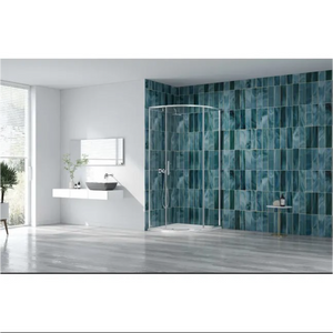 Modern bathroom featuring a curved quadrant shower enclosure with chrome frame and clear glass doors, set against a striking teal blue-green marbled effect tile wall, complemented by grey wood-effect flooring, white floating vanity unit with black vessel basin, and large window with natural light