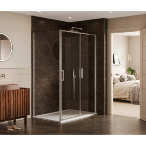 Modern bathroom featuring a Merlyn 6 Series chrome framed sliding shower enclosure with dark marble tiled walls, white base tray and brushed metal handles, positioned in a luxurious ensuite with beige walls, wooden vanity cabinet, circular mirror and view into bedroom beyond