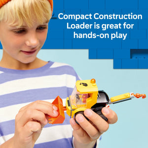 Child wearing striped purple and white shirt playing with yellow and orange LEGO construction loader toy against blue background with text reading Compact Construction Loader is great for hands-on play