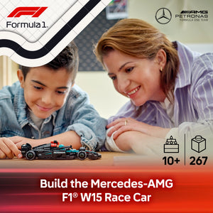 An adult and child assembling a black and turquoise LEGO Mercedes-AMG Formula 1 W15 race car model on a wooden surface, with Formula 1 and AMG Petronas branding visible, showing the completed miniature car alongside packaging details indicating 10+ age rating and 267 pieces