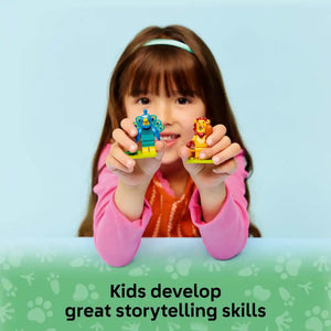 Young child wearing pink long-sleeved shirt and white headband holding two colorful LEGO minifigures - a blue peacock and yellow lion - against light blue background with green grass pattern and text stating Kids develop great storytelling skills