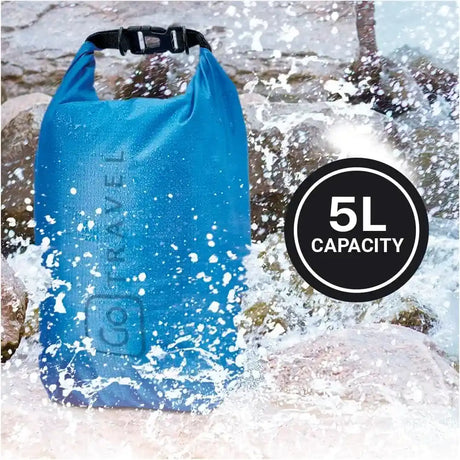 Blue waterproof dry bag with black shoulder strap being splashed by ocean waves, displaying 5L capacity badge in bottom right corner