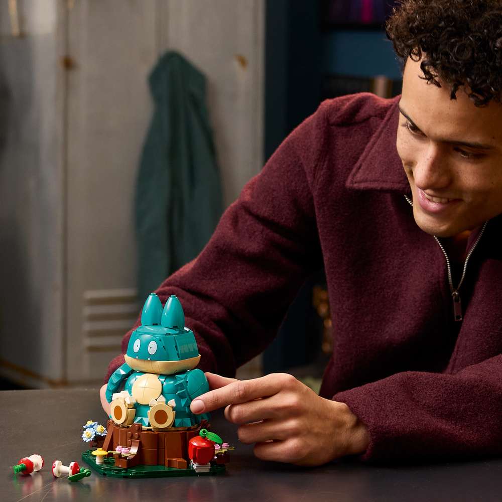LEGO Pokémon Munchlax 72150 - a child playing with the finished build. 757 pieces. Ages 18+.