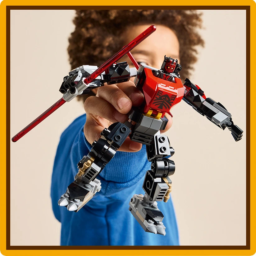 Child holding a red and black LEGO Darth Maul mech figure with extended limbs and a red staff against a neutral background, wearing a blue shirt