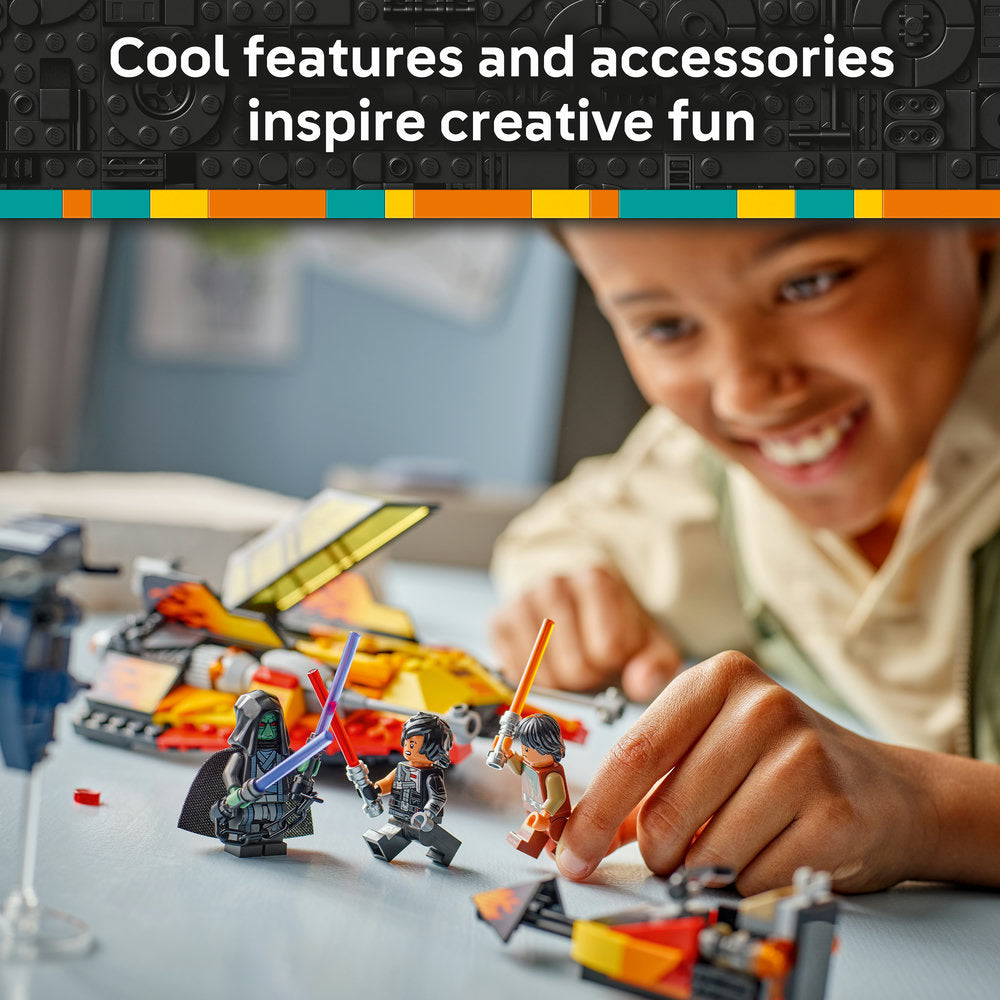 Child playing with LEGO Star Wars minifigures including Darth Vader and character with orange lightsaber, with colorful LEGO bricks and yellow and red spacecraft visible on table, demonstrating creative building and imaginative play
