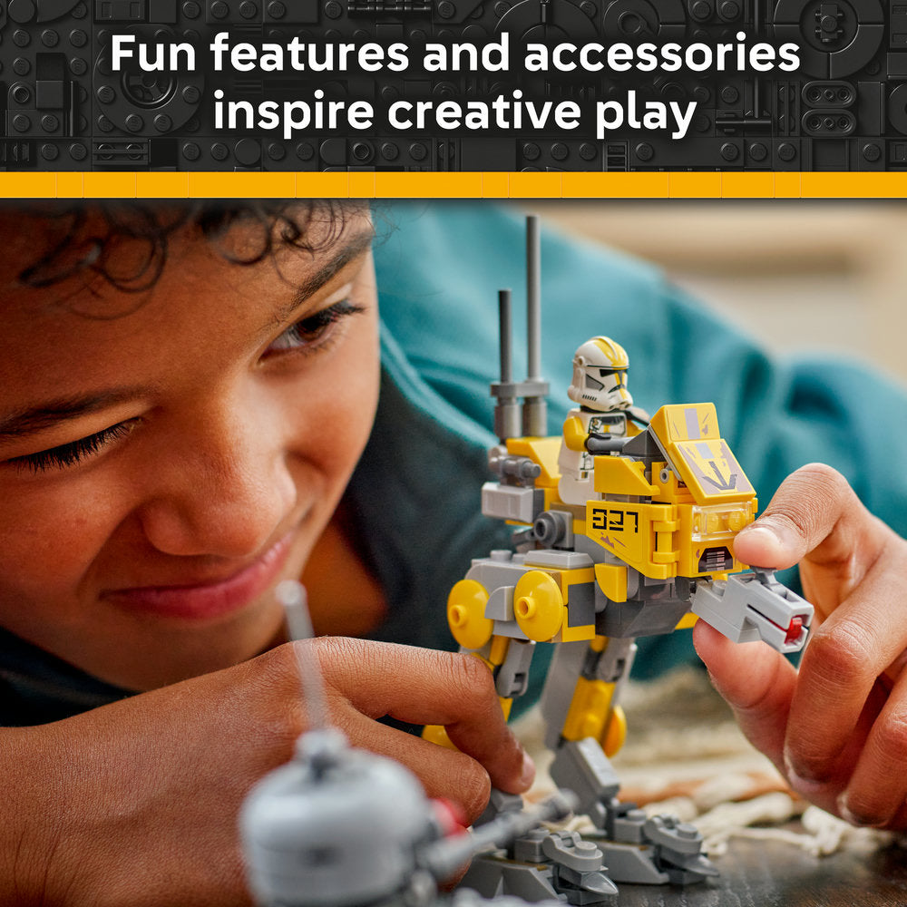 Child playing with LEGO Star Wars 75431 set featuring yellow and gray Clone Trooper minifigure and buildable vehicle with detailed bricks on sandy surface