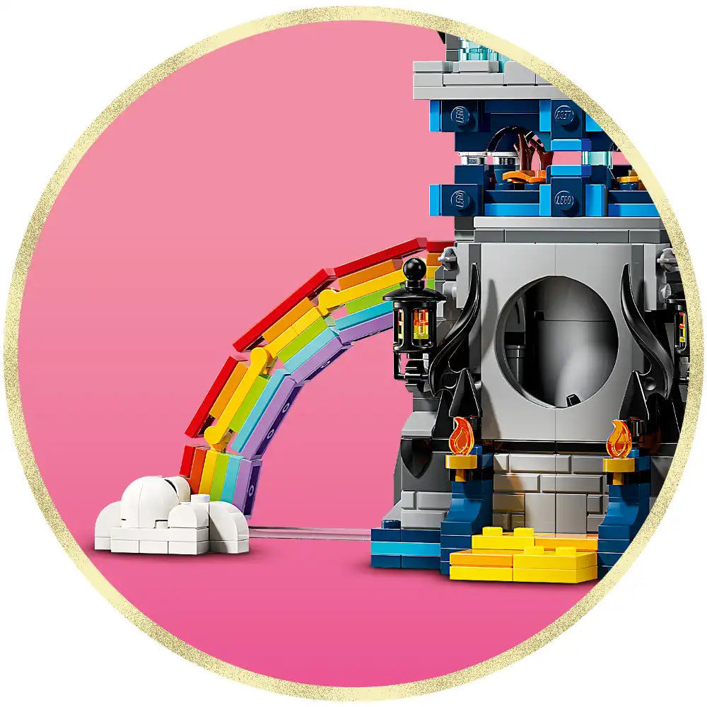 LEGO Wicked Emerald City and Kiamo Ko Castle set 75689 featuring a colorful rainbow bridge with white cloud base on the left, connected to a detailed gray castle structure with blue and black elements, orange flames, and yellow bricks on a pink circular background with gold glitter border