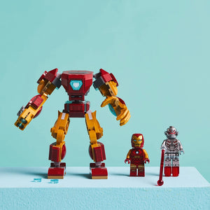 LEGO Iron Man Mech vs Ultron set 76307 featuring a large red and gold armored mech suit with articulated arms and legs, alongside three minifigures including Iron Man and Ultron characters against a light blue background