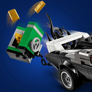 LEGO set 76309 Spider-Man vs. Venom Muscle Car featuring a green and white buildable muscle car with opening doors, black villain car, minifigures, and gold bar elements against a blue background