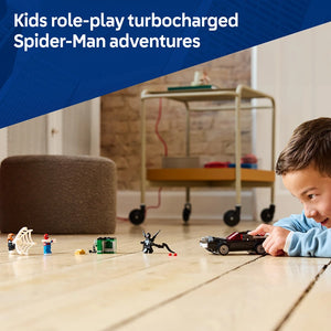 Young child playing with LEGO Spider-Man vs. Venom Muscle Car set on wooden floor, featuring minifigures and black vehicle, with storage shelving visible in background
