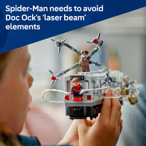 LEGO Spider-Man minifigure in red and blue suit inside detailed subway train car with white rope elements, held in child's hands, with Doc Ock multi-armed figure visible in blurred background, set 76321