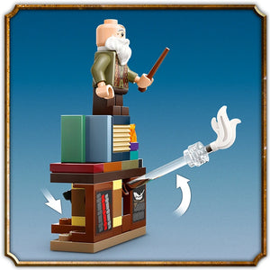 LEGO Hogwarts Castle Charms Class set 76442 featuring a minifigure wizard with white beard on a stacked brown wooden tower base with colorful books, a crystal wand with white swirls, and directional arrows against a blue background