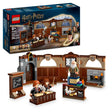 LEGO Harry Potter Hogwarts Castle Charms Class 76442 set featuring brown wooden classroom interior with minifigures, fireplace, desk, chalkboard and furniture pieces displayed with original packaging box