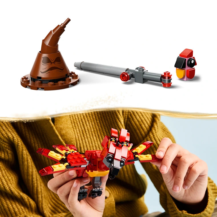LEGO Fawkes Dumbledore's Phoenix set 76448 showing brown wizard hat with accessories, gray cannon, red and black robot figure, and red and yellow phoenix minifigure being held in child's hands wearing yellow sweater