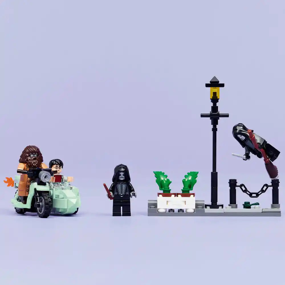 LEGO Harry Potter set 76459 featuring Hagrid and Harry's Privet Drive Escape with minifigures, flying car with chain, street lamp, potted plants, and accessories on light blue background