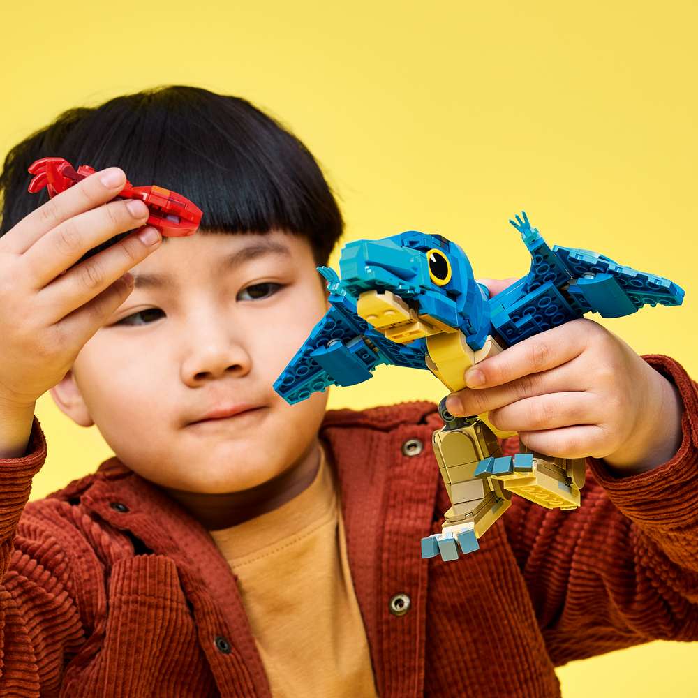 LEGO Jurassic World Baby Dinosaur: Pteranodon 77977 - a child playing with the finished build. 373 pieces. Ages 7+.