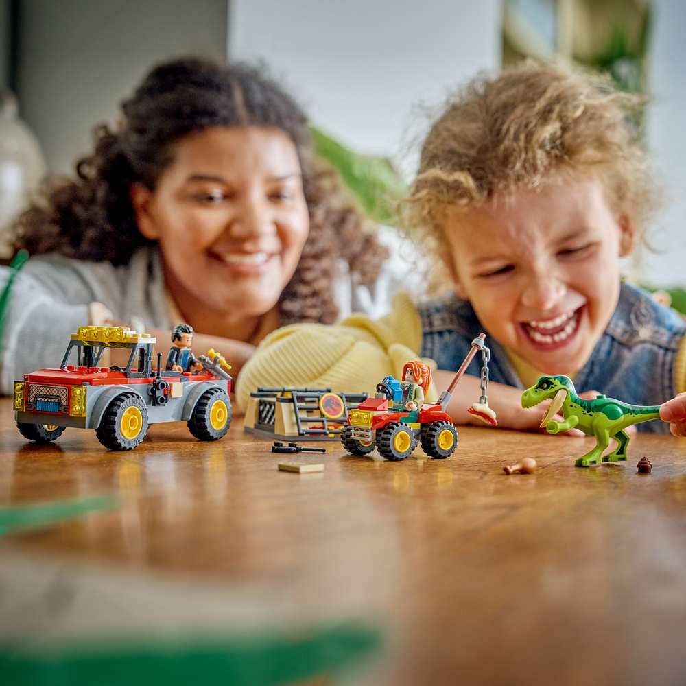 LEGO Jurassic World Young T. rex Transport Truck 77978 - a child playing with the finished build. 115 pieces. Ages 4+.