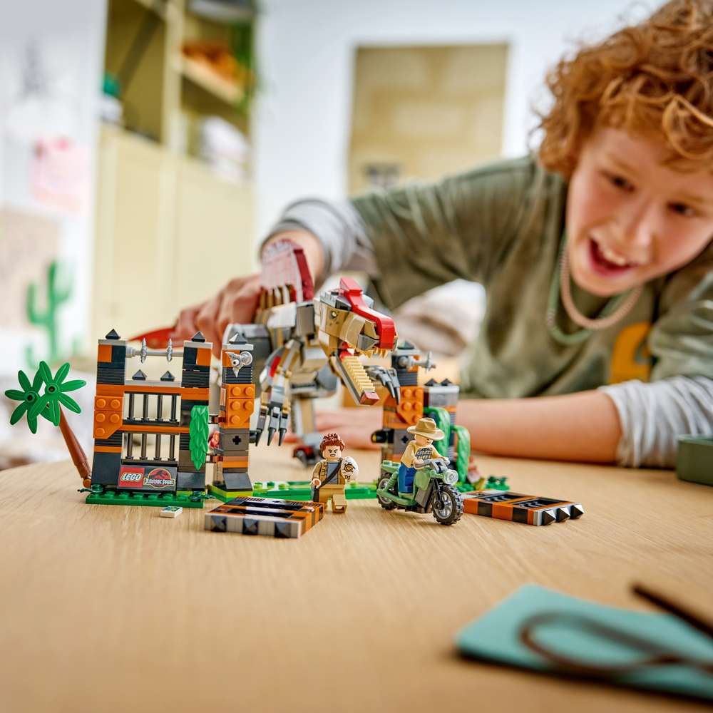 LEGO Jurassic World Spinosaurus Dinosaur Escape 77982 - a child playing with the finished build. 820 pieces. Ages 9+.