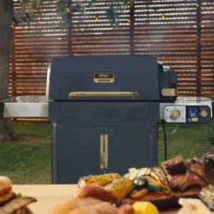 Blue grill with food on a table outdoors