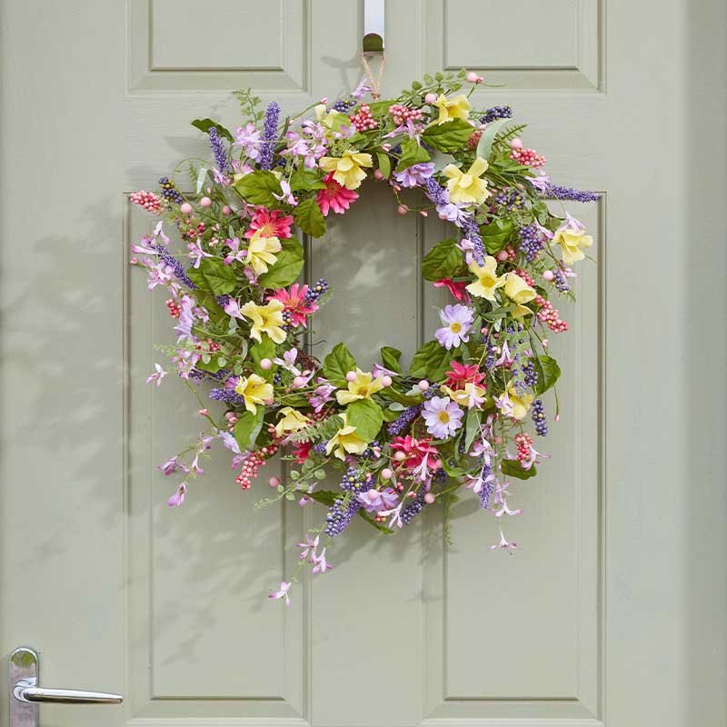 Colorful spring flower wreath hanging on pale green door featuring pink, purple, yellow and red blooms with green foliage and trailing vines, 45cm diameter Smart Garden design