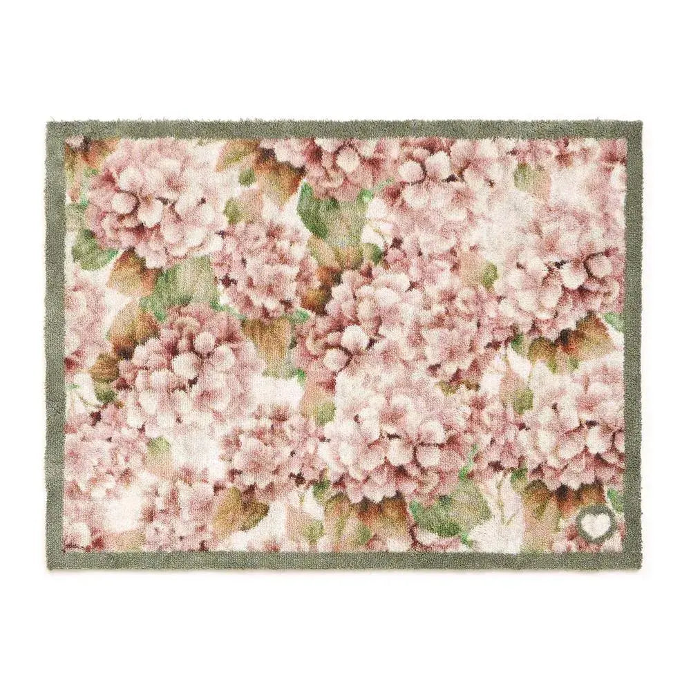 Hug Rug doormat 65cm x 85cm featuring wild hydrangea floral design with pink and white clustered flowers, green leaves, and brown stems on cream background with sage green border