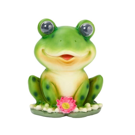 Green smiling frog garden light with bulging eyes, cream belly, pink flower decoration and solar panel eyes on white background