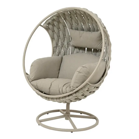 Kaemingk Serenity Swivel Egg Chair in beige woven rattan with cushioned grey upholstered seat and back pillow on metal stand base